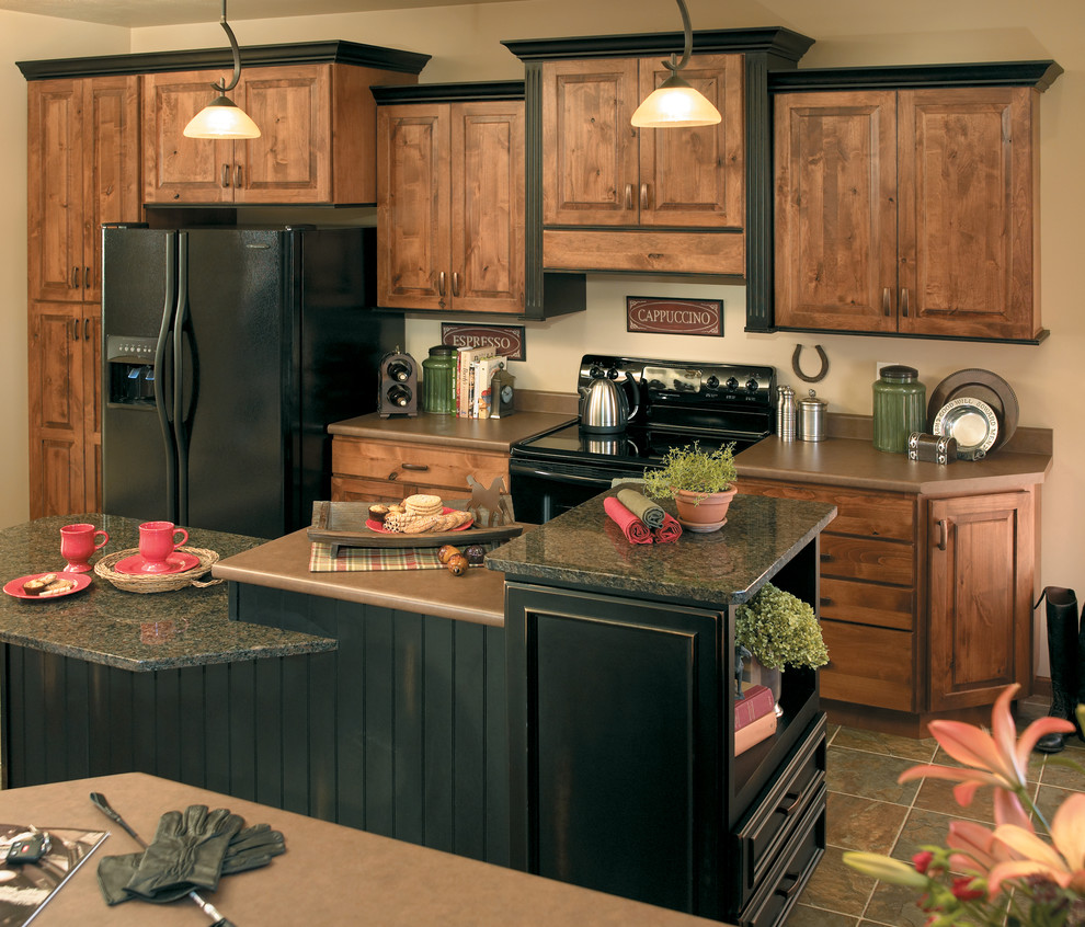 Large classic kitchen/diner in Other with raised-panel cabinets, medium wood cabinets, black appliances and an island.