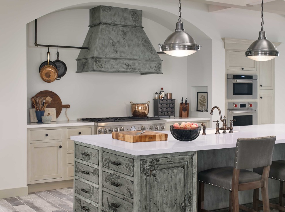 Inspiration for a large transitional l-shaped porcelain tile and gray floor eat-in kitchen remodel in DC Metro with a farmhouse sink, beaded inset cabinets, white cabinets, quartzite countertops, beige backsplash, slate backsplash, stainless steel appliances, two islands and multicolored countertops