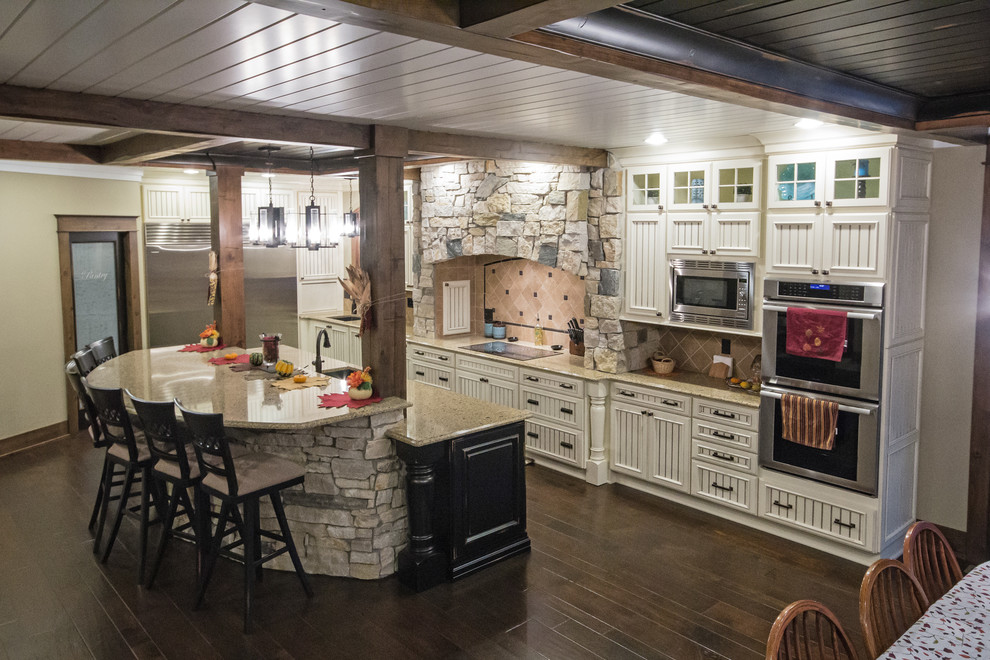 Expansive rustic kitchen in Grand Rapids with a submerged sink, recessed-panel cabinets, white cabinets, engineered stone countertops, stainless steel appliances, an island and dark hardwood flooring.
