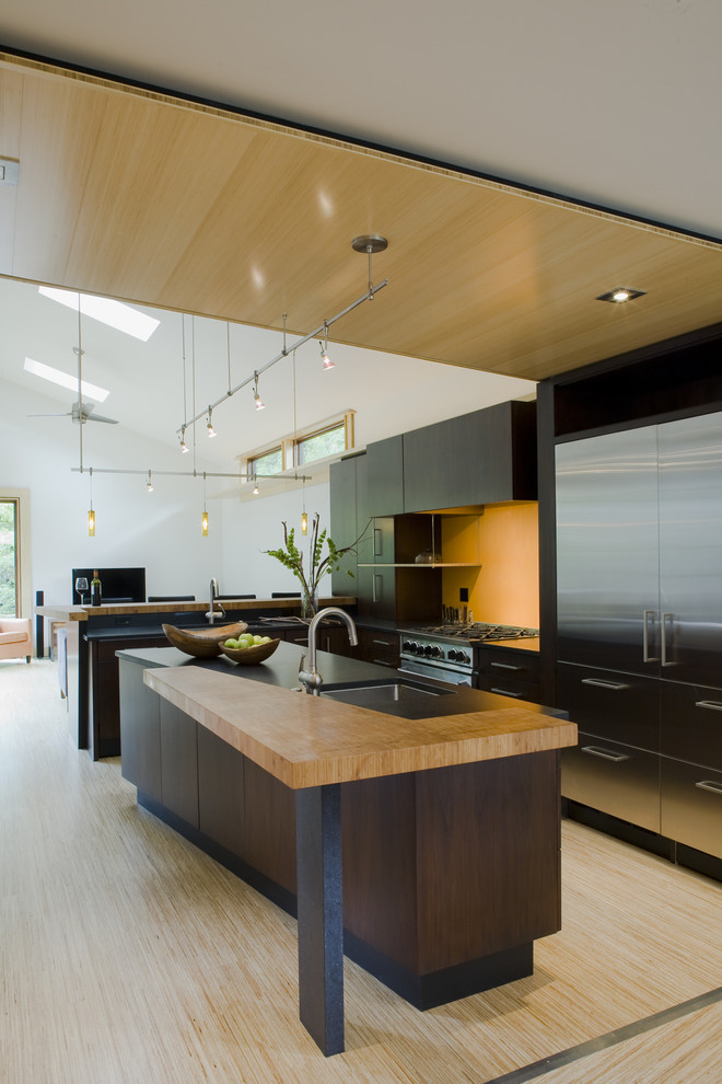Example of a trendy galley open concept kitchen design in DC Metro with stainless steel appliances and a single-bowl sink