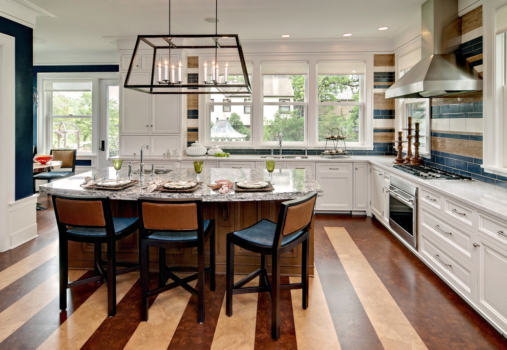 Photo of a classic l-shaped kitchen in Minneapolis with recessed-panel cabinets, white cabinets, multi-coloured splashback and an island.