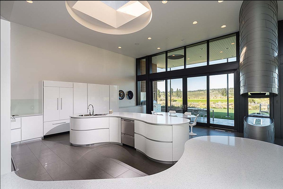 Example of a trendy u-shaped eat-in kitchen design in Other with an integrated sink, flat-panel cabinets, white cabinets, quartzite countertops, green backsplash, glass sheet backsplash and stainless steel appliances