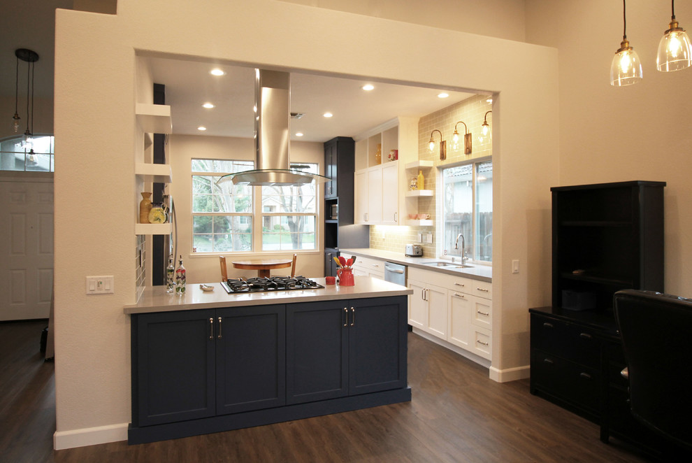 Inredning av ett eklektiskt mellanstort kök, med en dubbel diskho, skåp i shakerstil, blå skåp, bänkskiva i kvarts, grönt stänkskydd, stänkskydd i tunnelbanekakel, rostfria vitvaror, vinylgolv, en halv köksö och brunt golv