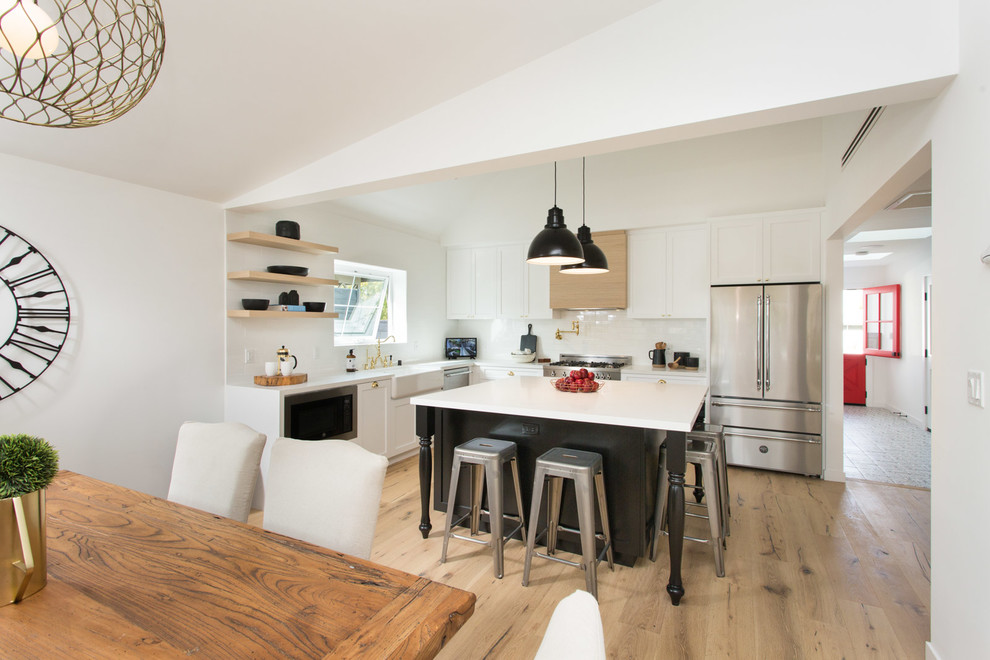 Kitchen - cottage kitchen idea in Los Angeles with a farmhouse sink, shaker cabinets, white cabinets and quartzite countertops