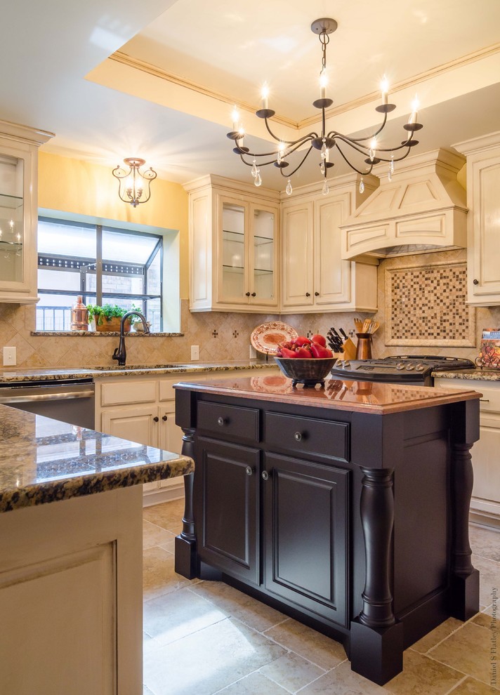 Example of a mid-sized classic u-shaped porcelain tile eat-in kitchen design in Dallas with a double-bowl sink, raised-panel cabinets, distressed cabinets, granite countertops, beige backsplash, porcelain backsplash, colored appliances and an island