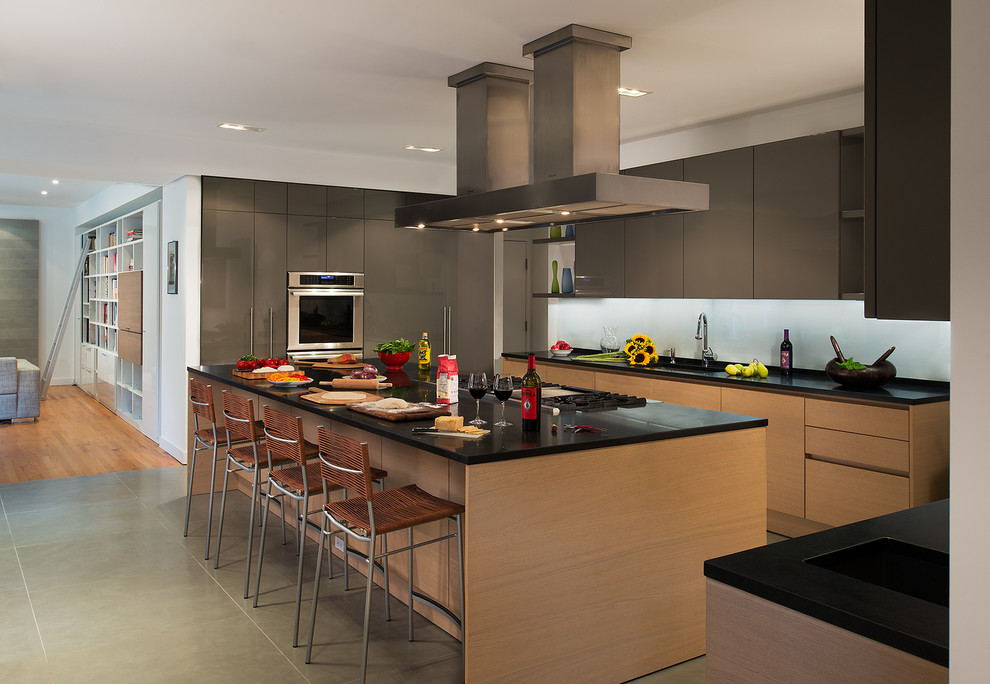 Moderne Küche in L-Form mit flächenbündigen Schrankfronten, hellbraunen Holzschränken, Küchengeräten aus Edelstahl und Kücheninsel in Washington, D.C.