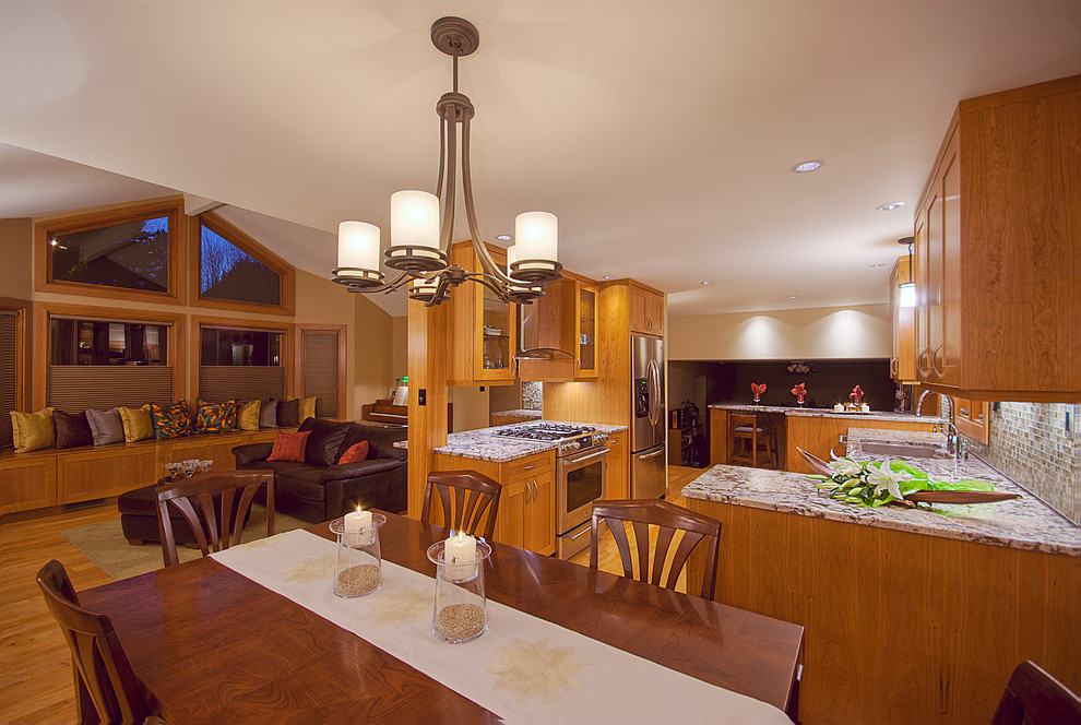 Large contemporary open plan kitchen in Denver with medium wood cabinets and stainless steel appliances.