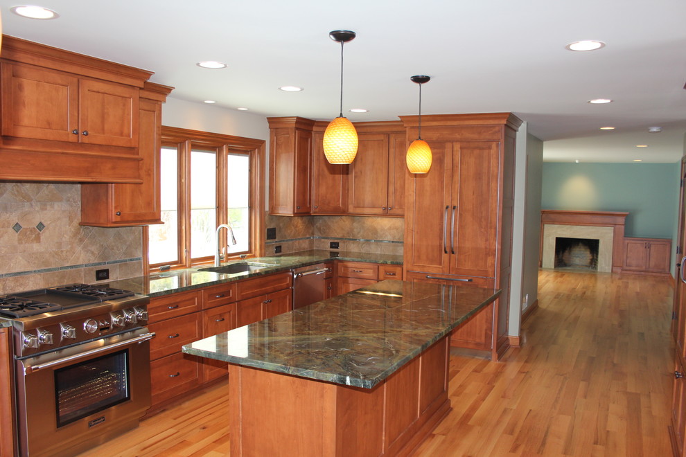 Example of a huge transitional galley light wood floor and beige floor open concept kitchen design in Columbus with an undermount sink, shaker cabinets, medium tone wood cabinets, granite countertops, beige backsplash, ceramic backsplash, stainless steel appliances, an island and gray countertops