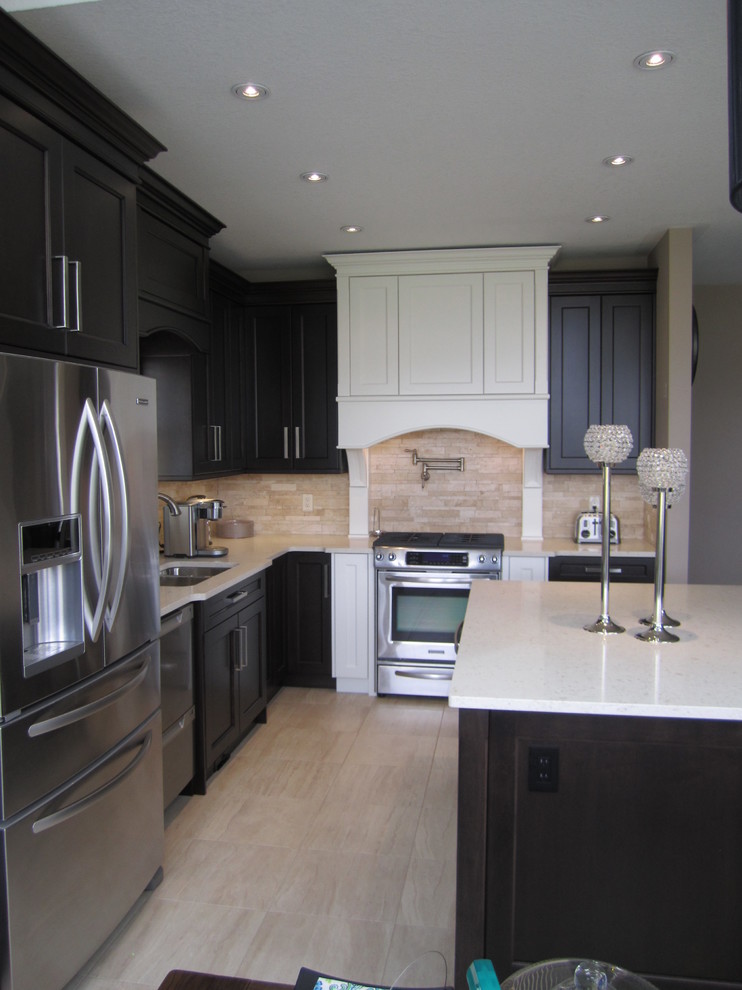 Inspiration for a transitional l-shaped eat-in kitchen remodel in Toronto with a drop-in sink, shaker cabinets, dark wood cabinets, beige backsplash, stainless steel appliances and an island