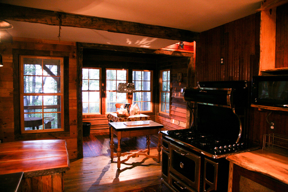 Example of a large classic galley dark wood floor open concept kitchen design in Baltimore with open cabinets, stainless steel countertops and an island