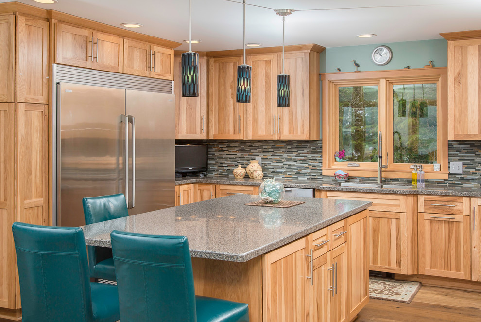 Inspiration for a mid-sized craftsman u-shaped medium tone wood floor eat-in kitchen remodel in Other with an undermount sink, shaker cabinets, light wood cabinets, solid surface countertops, green backsplash, mosaic tile backsplash, stainless steel appliances and an island