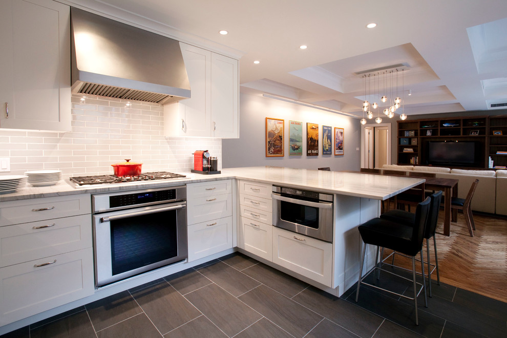 Example of a trendy open concept kitchen design in New York with shaker cabinets, white cabinets, white backsplash, subway tile backsplash and stainless steel appliances