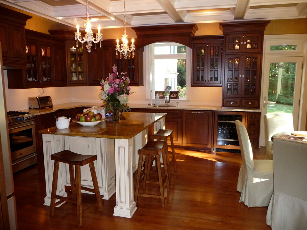 Mid-sized elegant l-shaped dark wood floor and brown floor eat-in kitchen photo in New York with a single-bowl sink, glass-front cabinets, dark wood cabinets, granite countertops, stainless steel appliances and an island