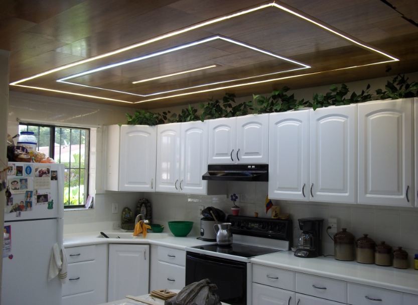 Design ideas for a modern l-shaped enclosed kitchen in Orange County with recessed-panel cabinets and white cabinets.