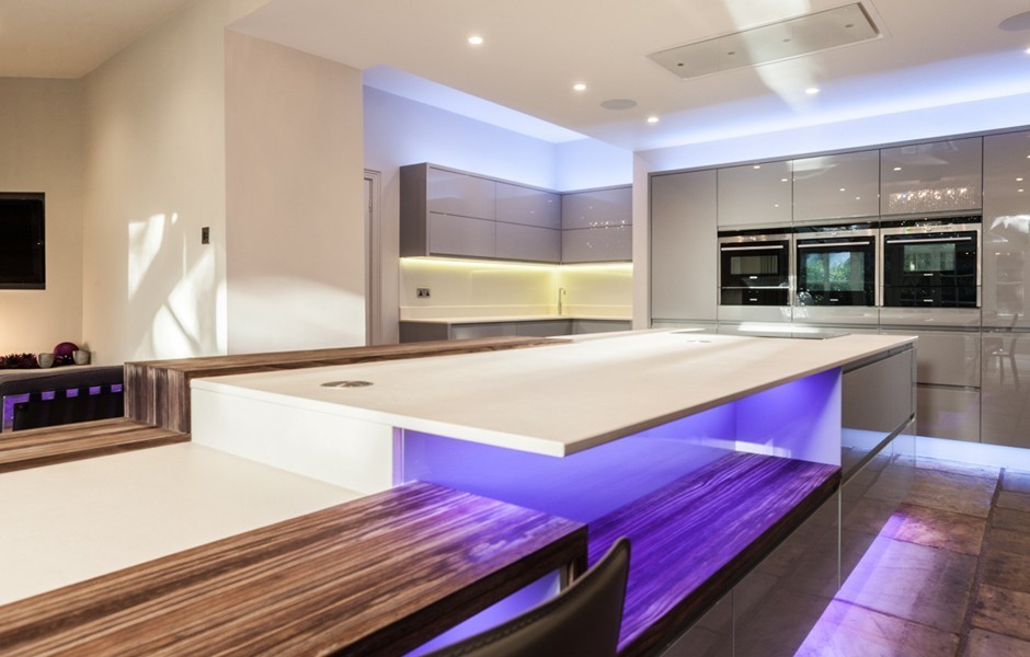 Photo of a large modern galley open plan kitchen in Other with a built-in sink, flat-panel cabinets, grey cabinets, laminate countertops, white splashback, stainless steel appliances, brick flooring and an island.