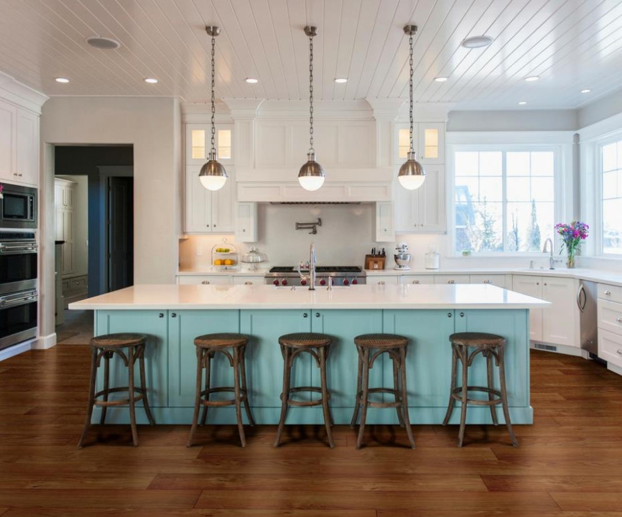Inspiration for a medium sized beach style u-shaped kitchen/diner in San Diego with a submerged sink, shaker cabinets, white cabinets, engineered stone countertops, white splashback, stainless steel appliances, medium hardwood flooring and an island.