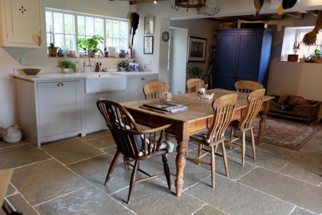 Photo of a medium sized rustic kitchen/diner in Other with a belfast sink, marble worktops and limestone flooring.