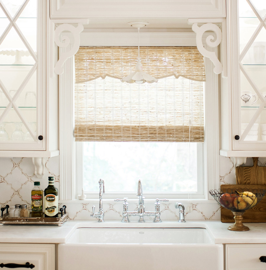 Inspiration for a mid-sized mediterranean l-shaped medium tone wood floor open concept kitchen remodel in Jacksonville with a farmhouse sink, glass-front cabinets, white cabinets, marble countertops, white backsplash, ceramic backsplash, paneled appliances and an island