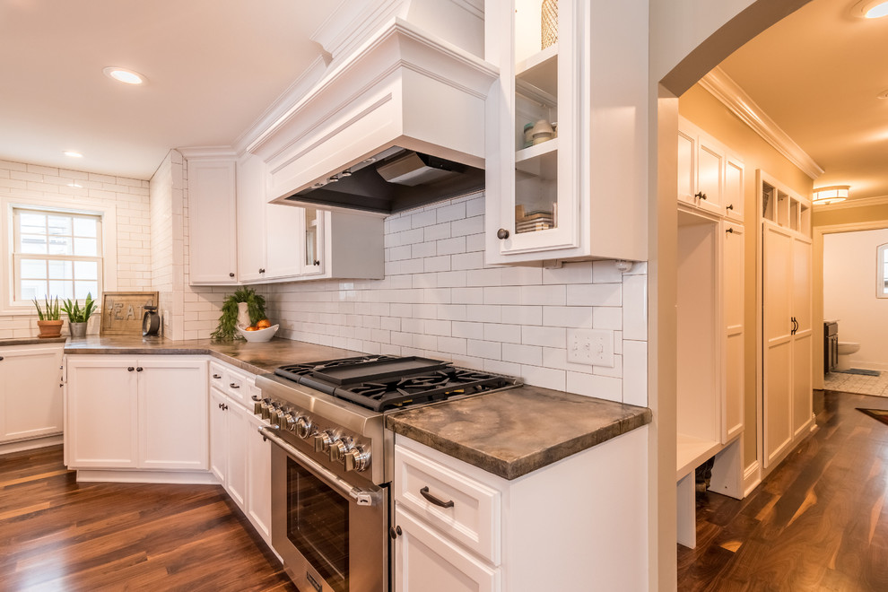 Enclosed kitchen - large contemporary l-shaped enclosed kitchen idea in Minneapolis with an undermount sink, glass-front cabinets, white cabinets, white backsplash and an island