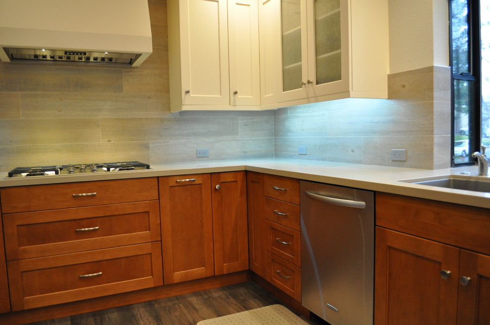 Inspiration for a small transitional u-shaped medium tone wood floor eat-in kitchen remodel in Sacramento with an undermount sink, shaker cabinets, medium tone wood cabinets, quartz countertops, gray backsplash, porcelain backsplash, stainless steel appliances and a peninsula