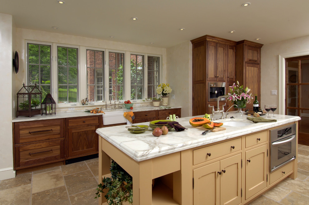 Mid-sized elegant single-wall eat-in kitchen photo in DC Metro with beaded inset cabinets, stainless steel appliances, an island, an undermount sink, medium tone wood cabinets, granite countertops and beige backsplash