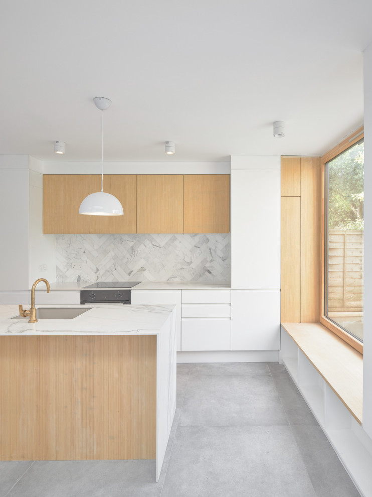 Design ideas for a medium sized urban galley open plan kitchen in London with a submerged sink, flat-panel cabinets, medium wood cabinets, engineered stone countertops, white splashback, ceramic splashback, coloured appliances, cement flooring, an island, grey floors and white worktops.