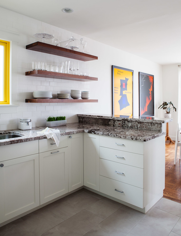 Small contemporary kitchen/diner in San Francisco with a submerged sink, shaker cabinets, white cabinets, granite worktops, white splashback, ceramic splashback, stainless steel appliances, ceramic flooring and no island.