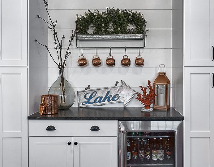Inspiration for a medium sized farmhouse kitchen/diner in Chicago with shaker cabinets, white cabinets, white splashback, tonge and groove splashback and stainless steel appliances.