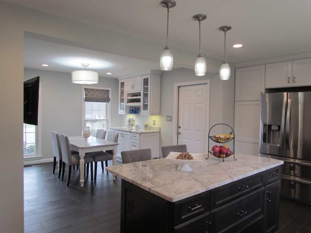 Mid-sized transitional u-shaped porcelain tile and gray floor eat-in kitchen photo in DC Metro with a farmhouse sink, shaker cabinets, white cabinets, granite countertops, gray backsplash, ceramic backsplash, stainless steel appliances and an island