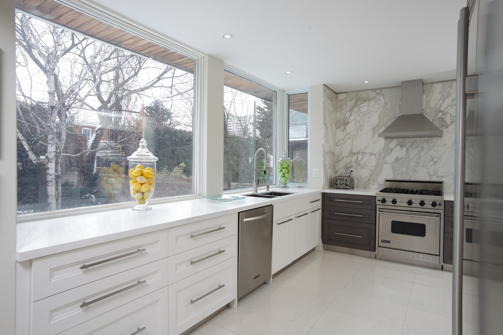 Contemporary l-shaped kitchen/diner in Toronto with a submerged sink, shaker cabinets, white cabinets, granite worktops, beige splashback, stone slab splashback, stainless steel appliances and ceramic flooring.