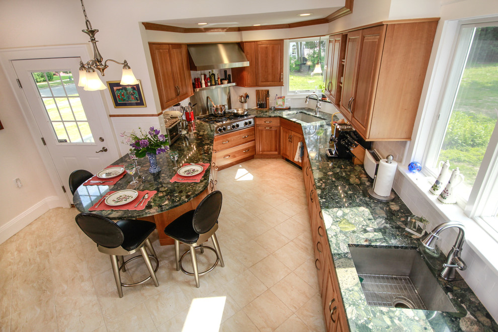 This is an example of a large traditional u-shaped kitchen/diner in Boston with a submerged sink, raised-panel cabinets, medium wood cabinets, granite worktops, white splashback, ceramic splashback, stainless steel appliances, porcelain flooring and a breakfast bar.