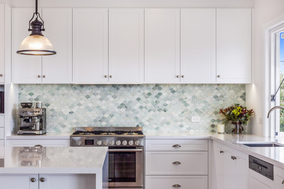 Inspiration for a mid-sized coastal u-shaped open concept kitchen remodel in Central Coast with multicolored backsplash, glass tile backsplash, stainless steel appliances and an island