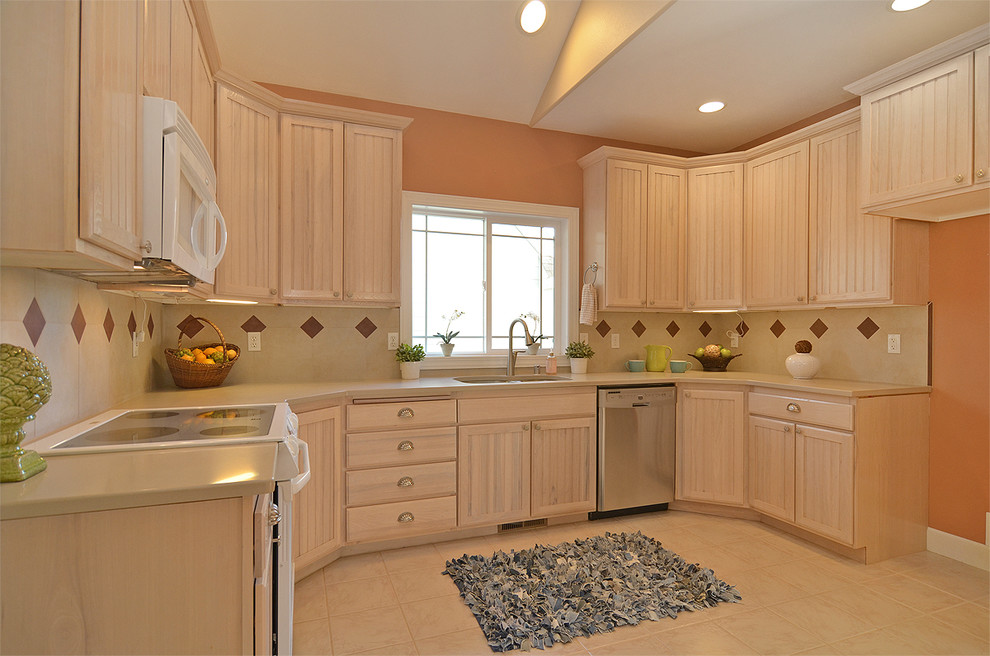 This is an example of a country kitchen in Seattle with a double-bowl sink, beaded cabinets, light wood cabinets, porcelain splashback and porcelain flooring.
