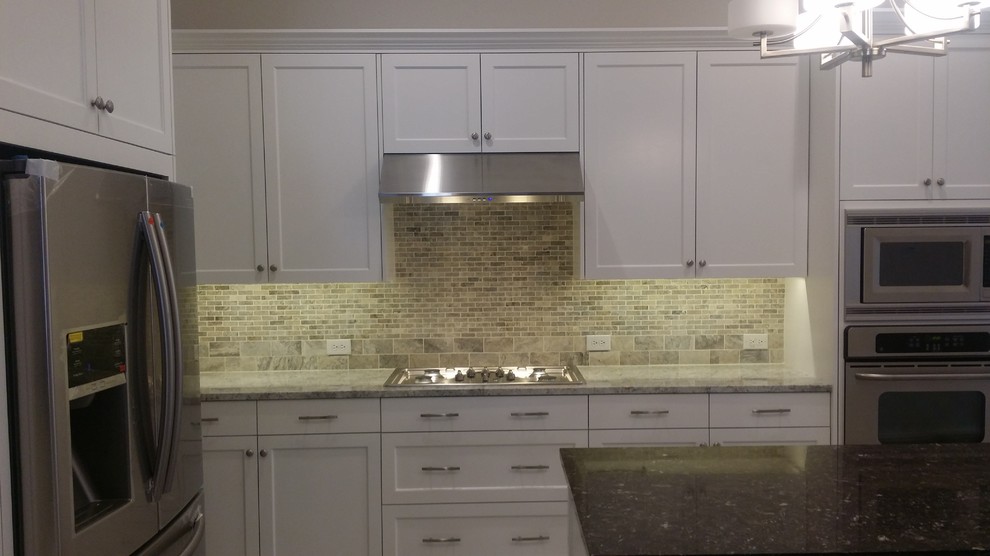 This is an example of a large classic u-shaped kitchen/diner in Dallas with a double-bowl sink, white cabinets, granite worktops, brown splashback, stone tiled splashback, stainless steel appliances, ceramic flooring, an island, grey floors and shaker cabinets.