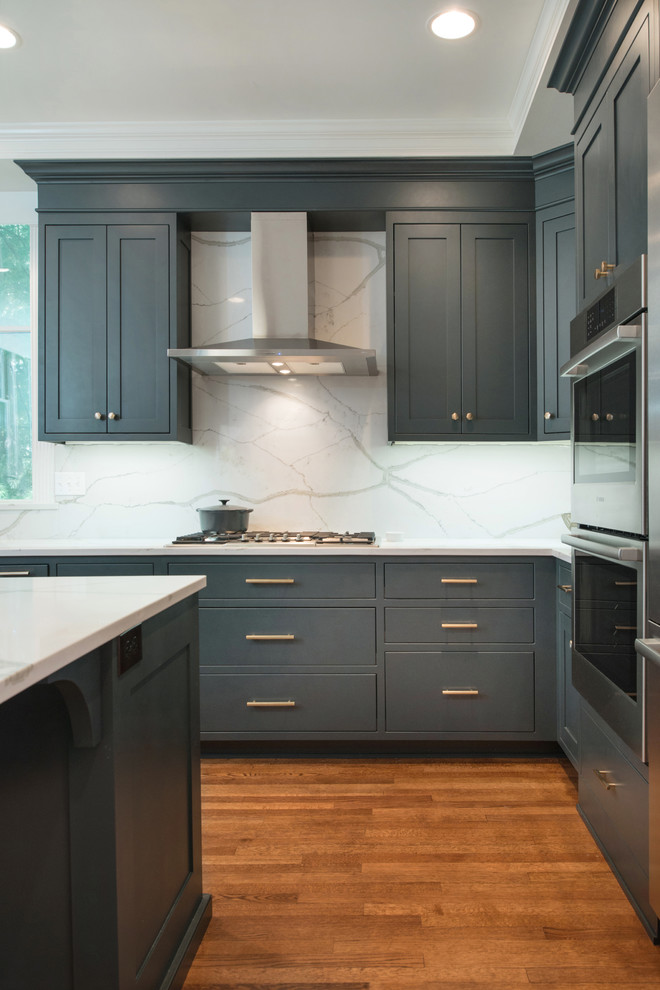Inspiration for a large timeless l-shaped kitchen pantry remodel in Kansas City with green cabinets, marble countertops, white backsplash, marble backsplash, stainless steel appliances and an island