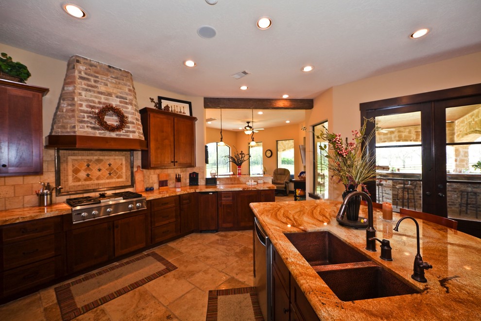 Example of a mid-sized tuscan l-shaped limestone floor and beige floor enclosed kitchen design in Houston with a double-bowl sink, shaker cabinets, dark wood cabinets, soapstone countertops, beige backsplash, stone tile backsplash, stainless steel appliances and an island