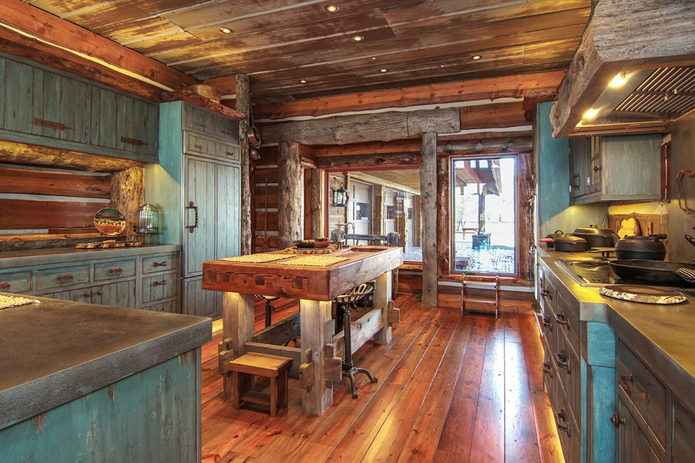 This is an example of a large rustic u-shaped enclosed kitchen in Wichita with distressed cabinets, zinc worktops, brown splashback, wood splashback, integrated appliances, medium hardwood flooring, an island and flat-panel cabinets.
