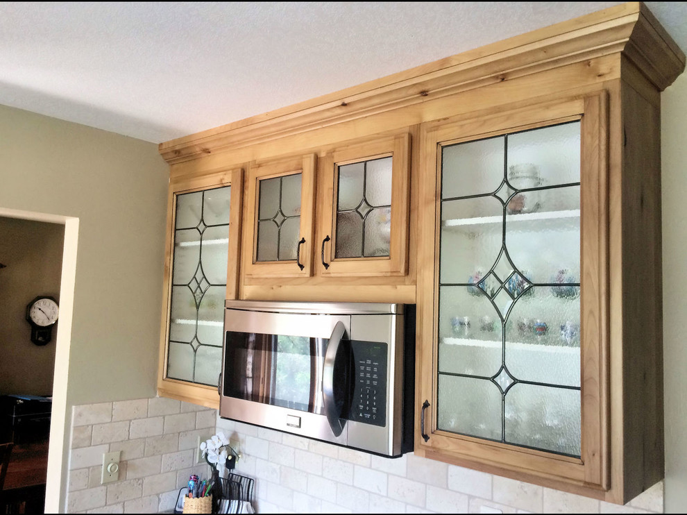This is an example of a classic kitchen in Denver with glass-front cabinets.