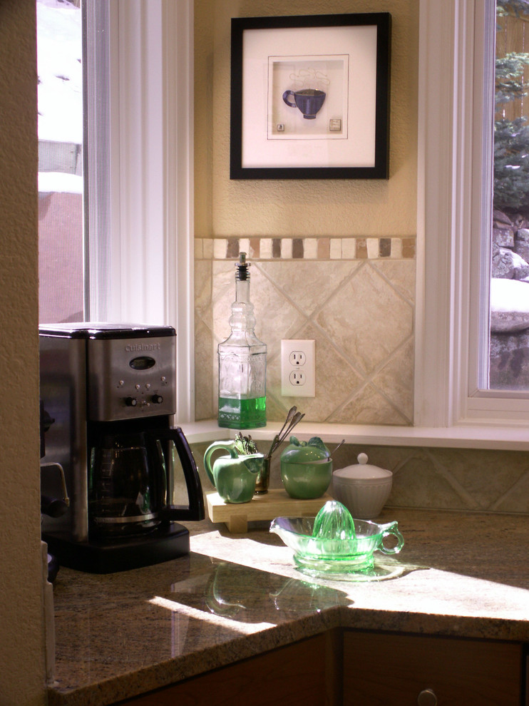 Foto di una cucina chic con ante in stile shaker, ante in legno scuro, top in granito, paraspruzzi beige, paraspruzzi in gres porcellanato e elettrodomestici in acciaio inossidabile