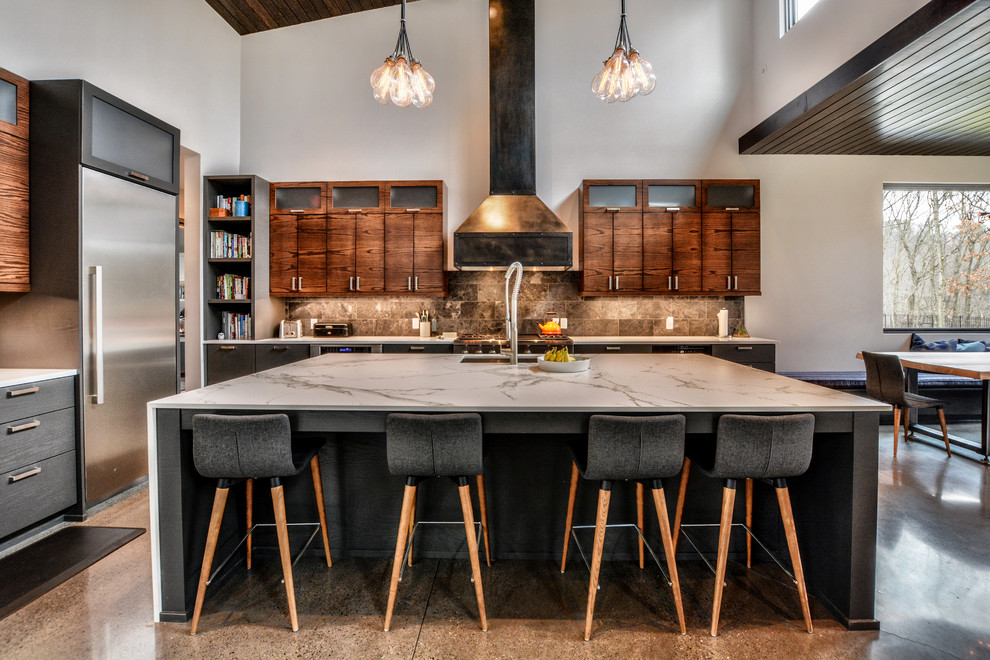 Large trendy l-shaped concrete floor and gray floor open concept kitchen photo in Other with an undermount sink, flat-panel cabinets, dark wood cabinets, gray backsplash, stainless steel appliances, an island, quartz countertops and stone tile backsplash