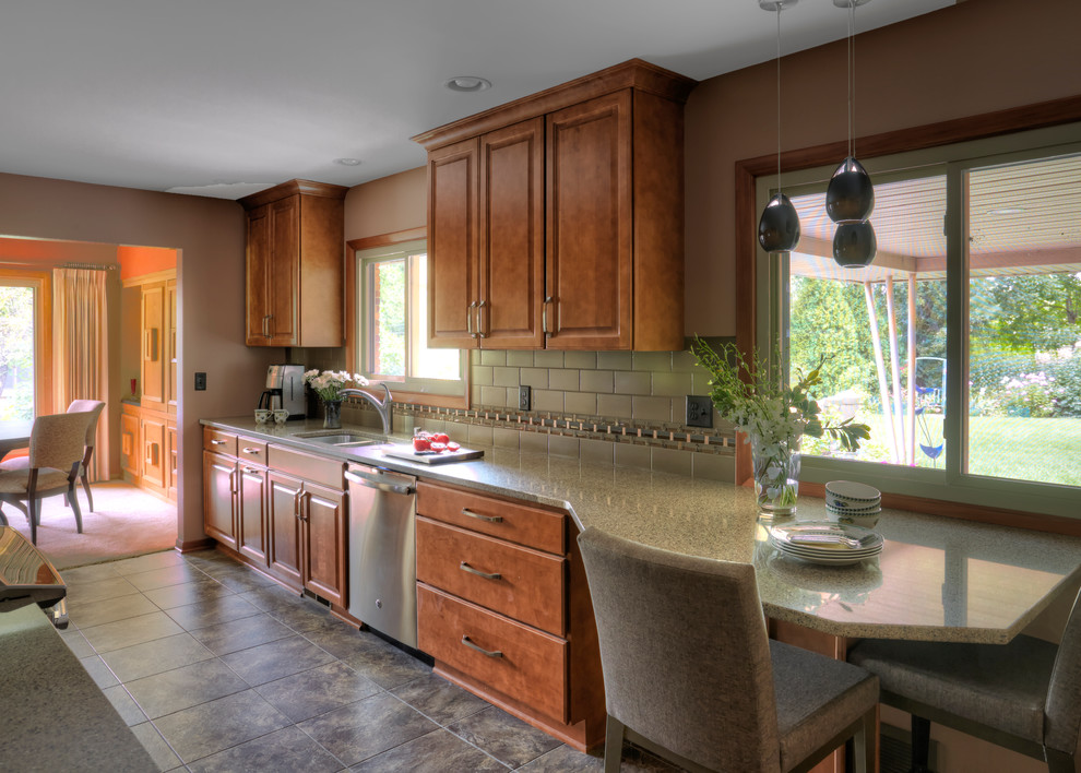 Inspiration for a small transitional galley vinyl floor enclosed kitchen remodel in Milwaukee with an undermount sink, raised-panel cabinets, medium tone wood cabinets, quartz countertops, multicolored backsplash, porcelain backsplash, stainless steel appliances and no island