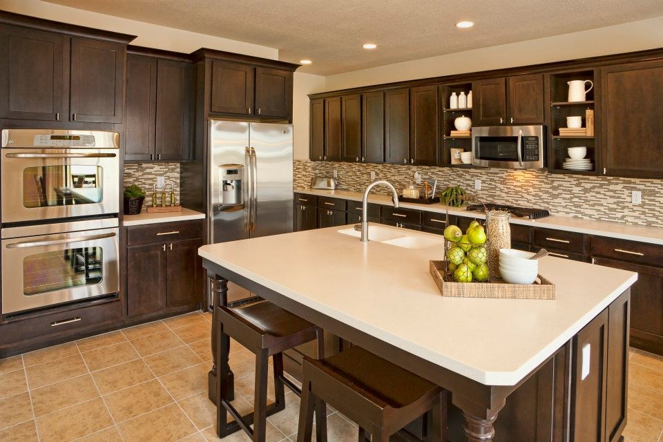 Enclosed kitchen - mid-sized transitional l-shaped terra-cotta tile enclosed kitchen idea in Salt Lake City with a double-bowl sink, recessed-panel cabinets, dark wood cabinets, multicolored backsplash, matchstick tile backsplash, stainless steel appliances and an island