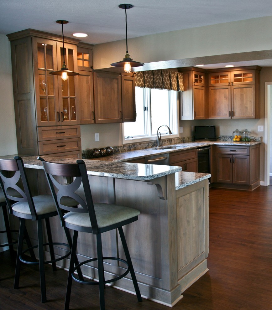 Inspiration for a large timeless u-shaped medium tone wood floor enclosed kitchen remodel in Other with an undermount sink, flat-panel cabinets, medium tone wood cabinets, granite countertops, stainless steel appliances and a peninsula