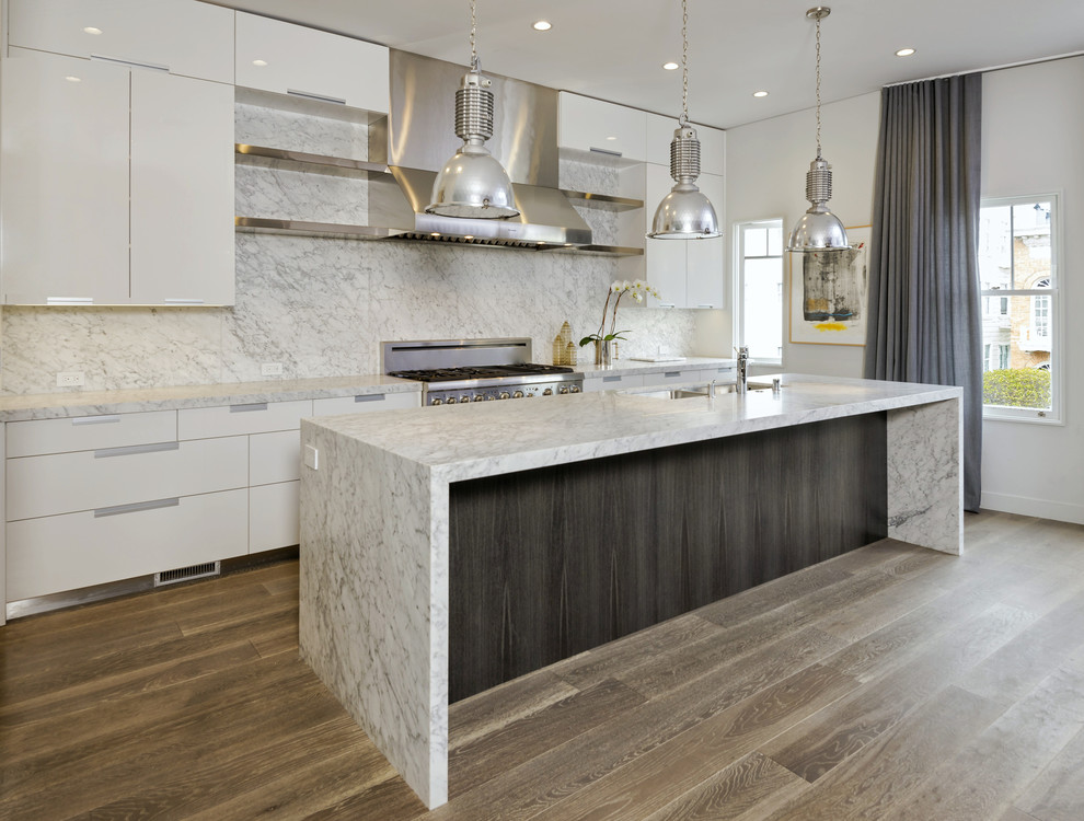 Design ideas for a large contemporary single-wall kitchen/diner in San Francisco with a submerged sink, flat-panel cabinets, white cabinets, marble worktops, stainless steel appliances and an island.