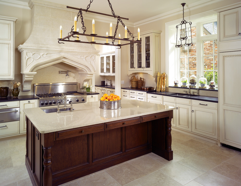 Example of a large classic u-shaped limestone floor eat-in kitchen design in Atlanta with an undermount sink, recessed-panel cabinets, white cabinets, quartz countertops, paneled appliances and an island