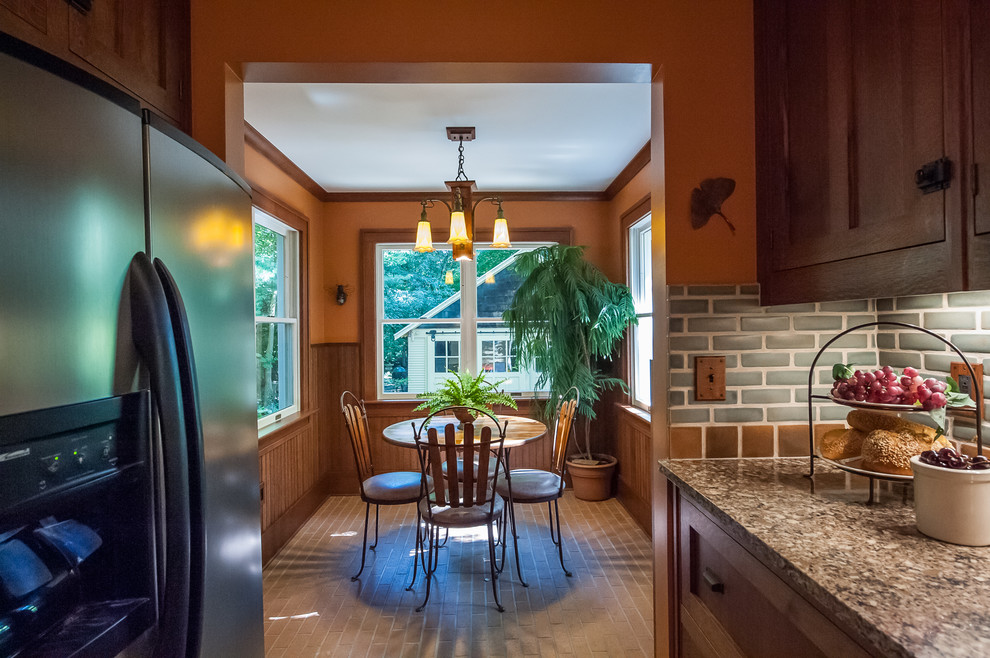 Small classic l-shaped enclosed kitchen in Detroit with a belfast sink, beaded cabinets, medium wood cabinets, engineered stone countertops, grey splashback, metro tiled splashback, stainless steel appliances, dark hardwood flooring and no island.