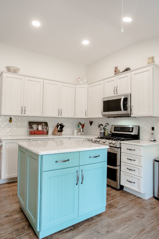 Eat-in kitchen - small transitional u-shaped medium tone wood floor and brown floor eat-in kitchen idea in Other with an undermount sink, louvered cabinets, white cabinets, white backsplash, ceramic backsplash, stainless steel appliances, an island and white countertops