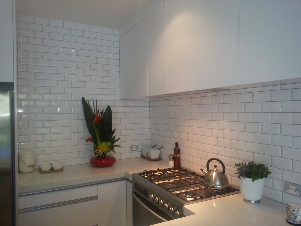 Kitchen - contemporary porcelain tile kitchen idea in Auckland with white backsplash and ceramic backsplash