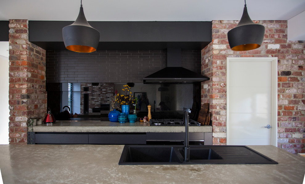 Idéer för ett modernt linjärt kök och matrum, med en dubbel diskho, släta luckor, svarta skåp, bänkskiva i betong, svart stänkskydd, glaspanel som stänkskydd, betonggolv, en köksö och grått golv
