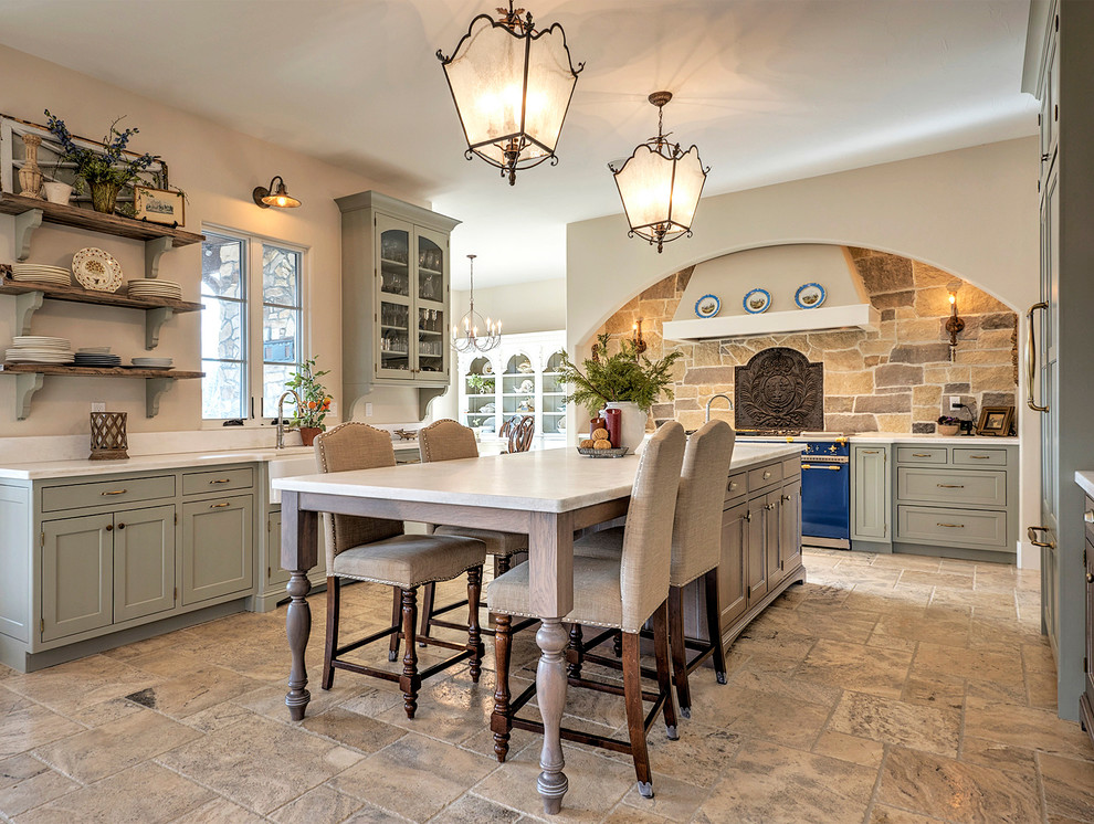 This is an example of a large classic u-shaped open plan kitchen in Denver with a belfast sink, shaker cabinets, grey cabinets, quartz worktops, beige splashback, stone tiled splashback, coloured appliances, an island, cement flooring and brown floors.